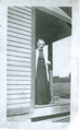 Alcesta Huntington standing on her porch (circa 1910)